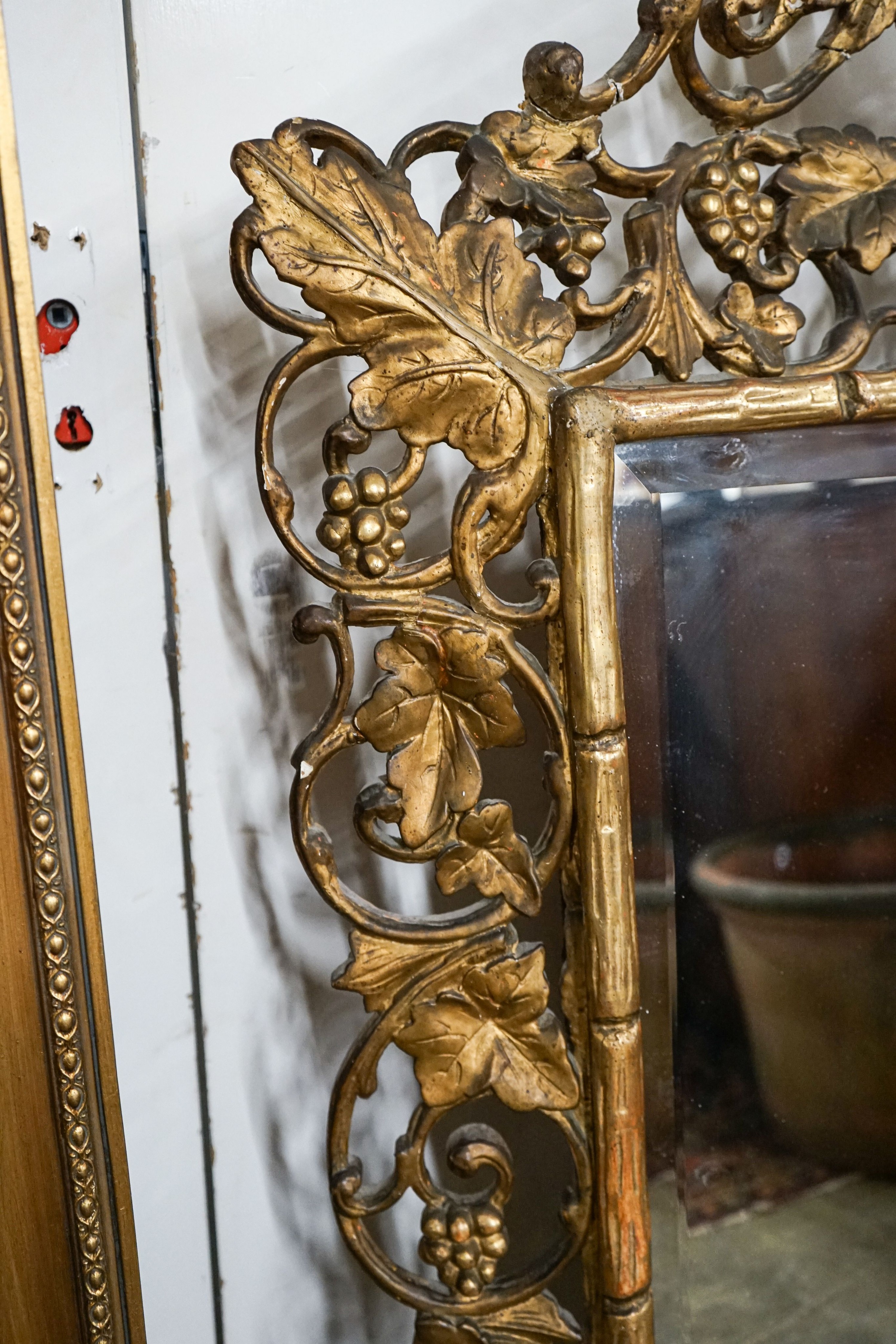 A Victorian carved giltwood and gesso rectangular wall mirror with pierced fruiting vine border, width 98cm, height 148cm